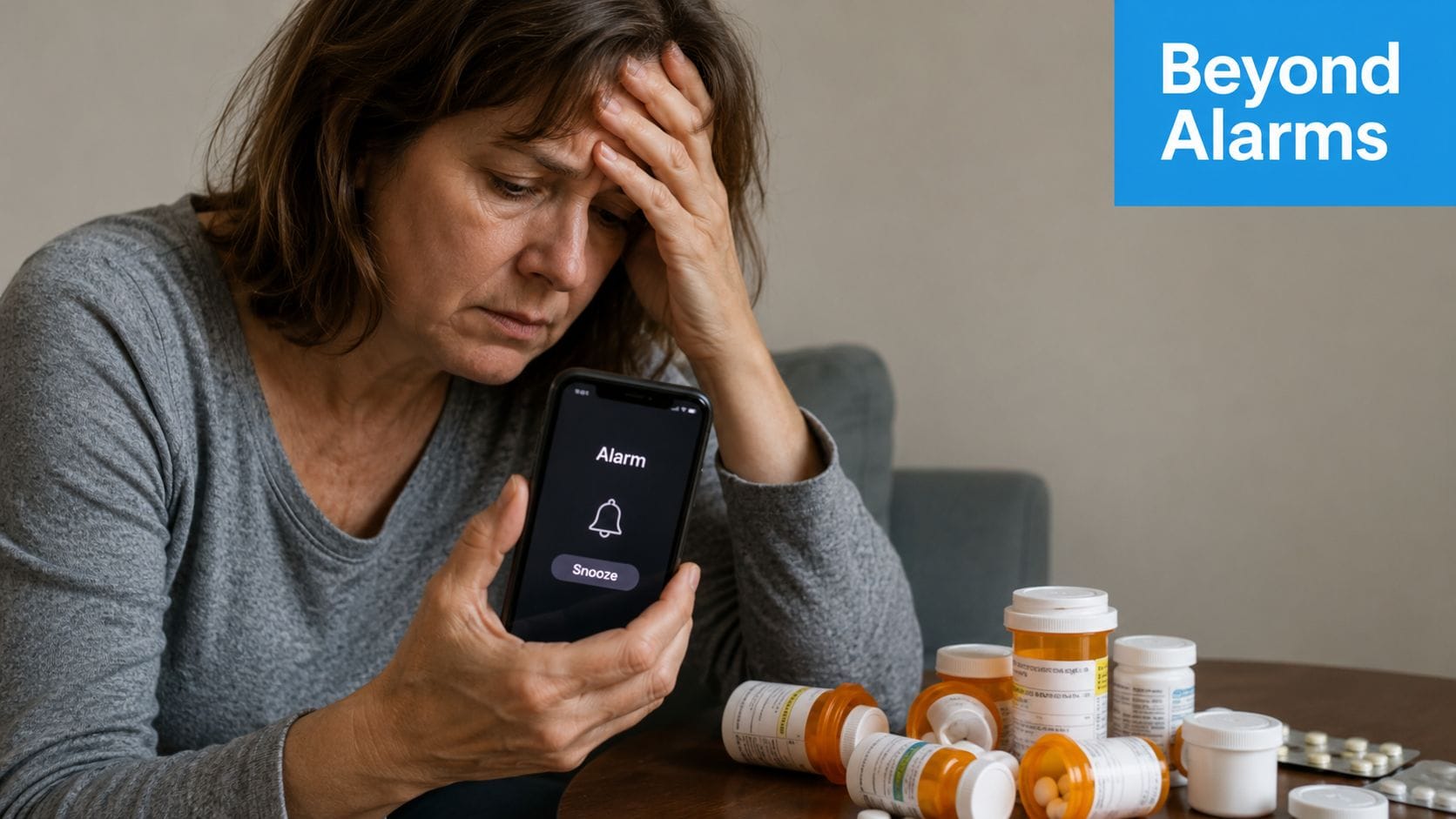 A distressed woman sits at a table with prescription medicine bottles while checking her phone alarm.