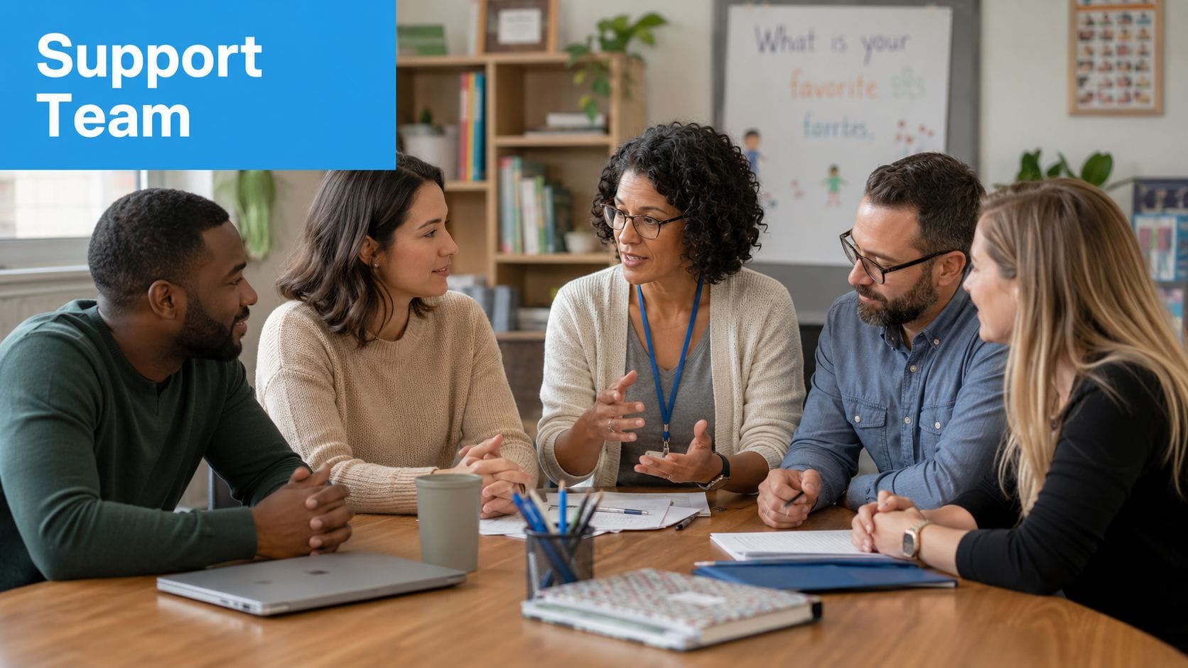 A diverse team of professionals collaborating in a meeting at a table in a bright office.